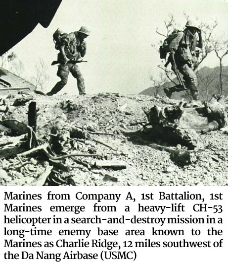 Photo of Marines from Company A, 1st Battalion, 1st Marines emerging from a heavy-lift CH-53 helicopter in a search-and-destroy mission in a long-time enemy base area known to the Marines as Charlie Ridge, 12 miles southwest of the Da Nang Airbase (USMC)