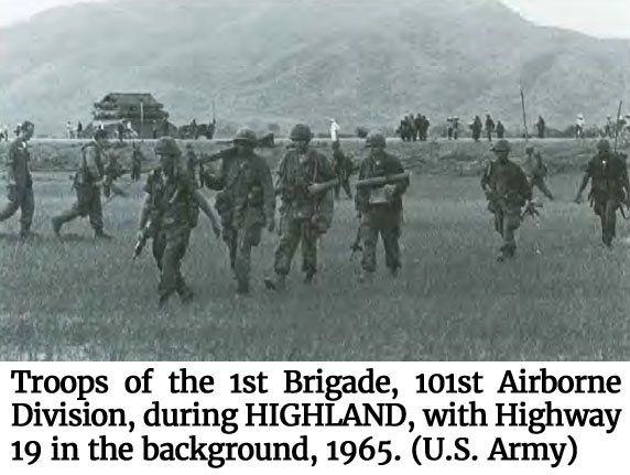 Photo provided by the U.S. Army of Troops of the 1st Brigade, 101st Airborne Division, during HIGHLAND, with Highway 19 in the background, 1965.