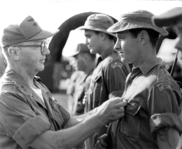 U.S. Army 1st  Aviation Brigade Commander, Major General Robert R. Williams, presenting awards. Royal Australian Navy Able Seaman John Peart, received the U.S. Army's Asir Medal with Oak Leaf clusters, for "meritorious achievement while participating in aerial flight." Like many men in the 135th AHC, Peart completed more than 200 combat missions before rotating home. (RAN photo)