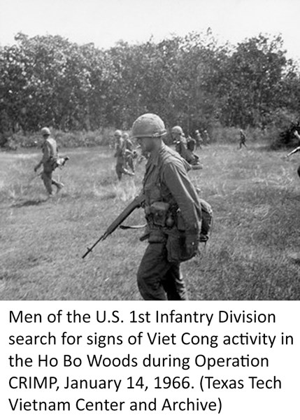Men of the U.S. 1st Infantry Division search for signs of Viet Cong activity in the Ho Bo Woods during Operation CRIMP, January 14, 1966. (Texas Tech Vietnam Center and Archive)