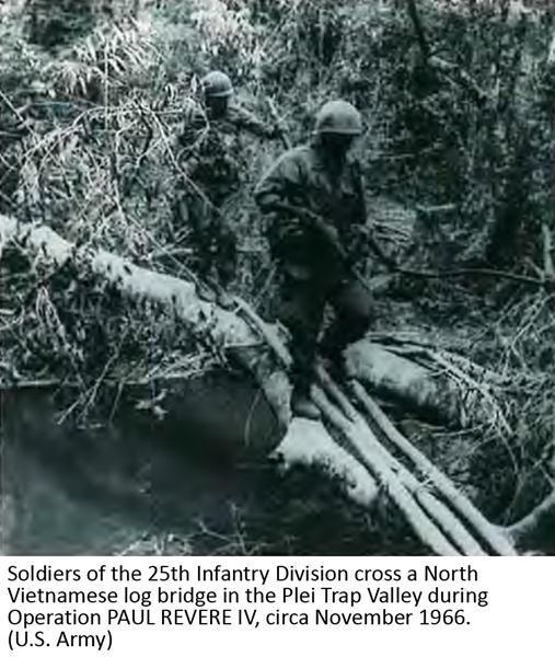 Soldiers of the 25th Infantry Division cross a North Vietnamese log bridge in the Plei Trap Valley during Operation PAUL REVERE IV, circa November 1966. (U.S. Army)