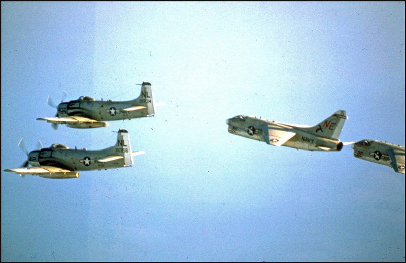 Two A-1 Skyraider attack aircraft and two A-7 Corsair II attack aircraft over the Gulf of Tonkin head toward North Vietnam on a combat mission, January 1968. (U.S. Navy)