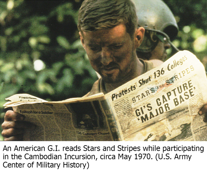 An American G.I. reads Stars and Stripes while participating in the Cambodian Incursion, circa May 1970. (U.S. Army Center of Military History)