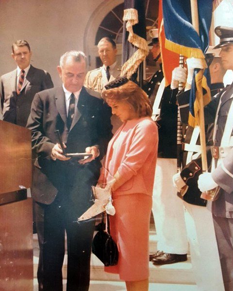 Barbara Walling Burke, 19 at the time, receives her late husband's Silver Star Medal from President Lyndon B. Johnson at a ceremony at the White House, August 22, 1964. (Photo property of Barbara Walling Burke)