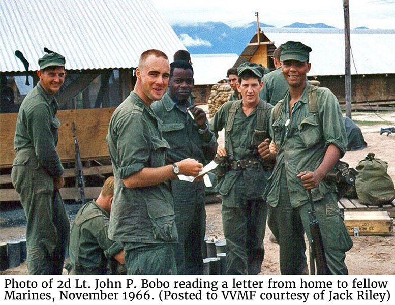 Photo of 2d Lt. John P. Bobo reading a letter from home to fellow Marines, November 1966. (Posted to VVMF courtesy of Jack Riley)