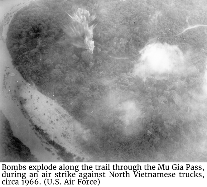 U.S. Air Force photo of bombs explode along the trail through the Mu Gia Pass, during an air strike against North Vietnamese trucks, circa 1966.