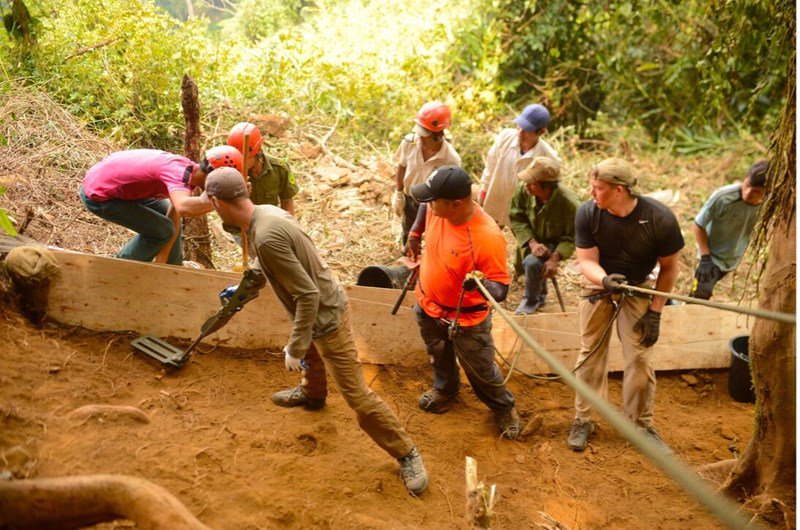 DPAA Recovery Team members look on as U.S. Air Force Technical Sergeant David Speigel scans an excavation unit for hazardous materials in Kon Tum Province, Socialist Republic of Vietnam, March 23, 2016. The team is searching for remains of a downed American pilot. (Department of Defense)