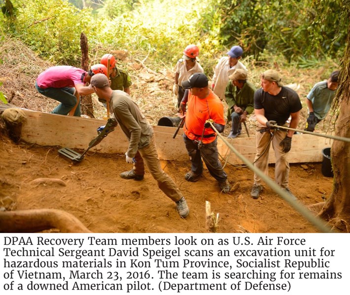 DPAA Recovery Team members look on as U.S. Air Force Technical Sergeant David Speigel scans an excavation unit for hazardous materials in Kon Tum Province, Socialist Republic of Vietnam, March 23, 2016. The team is searching for remains of a downed American pilot. (Department of Defense)