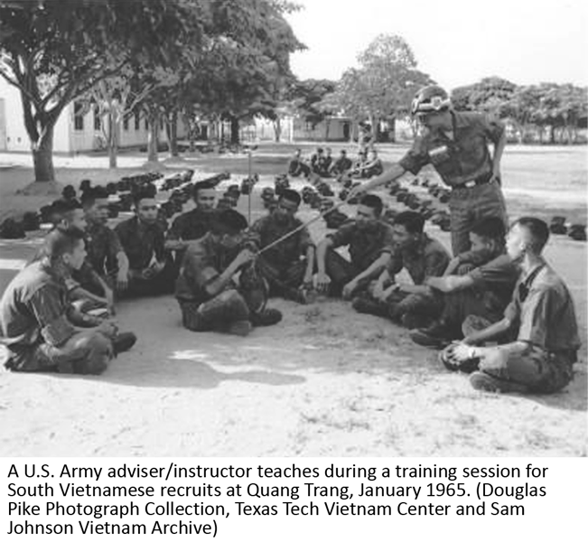 A U.S. Army adviser/instructor teaches during a training session for South Vietnamese recruits at Quang Trang, January 1965. (Douglas Pike Photograph Collection, Texas Tech Vietnam Center and Sam Johnson Vietnam Archive)