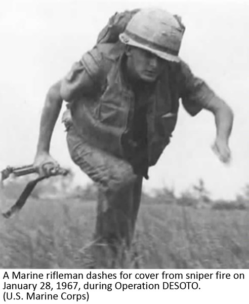A Marine rifleman dashes for cover from sniper fire on January 28, 1967, during Operation DESOTO. (U.S. Marine Corps)
