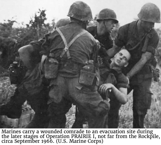 Marines carry a wounded comrade to an evacuation site during the later stages of Operation PRAIRIE I, not far from the Rockpile, circa September 1966. (U.S. Marine Corps)