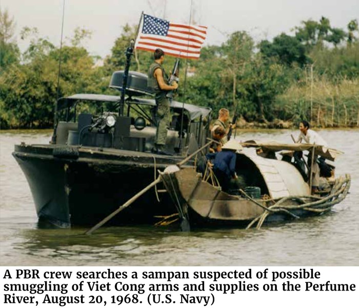 A PBR crew searches a sampan suspected of possible smuggling of Viet Cong arms and supplies on the Perfume River, August 20, 1968. (U.S. Navy)