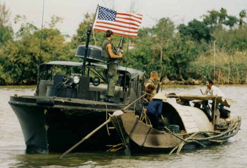 A PBR crew searches a sampan suspected of possible smuggling of Viet Cong arms and supplies on the Perfume River, August 20, 1968. (U.S. Navy)