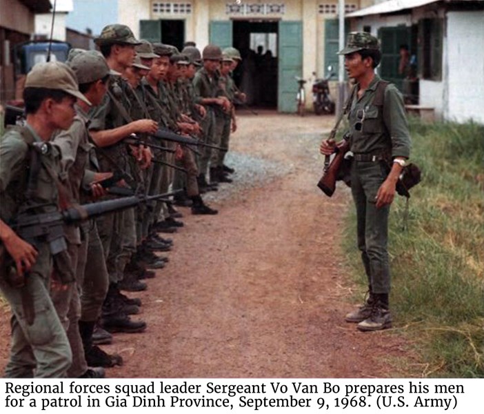 Regional forces squad leader Sergeant Vo Van Bo prepares his men for a patrol in Gia Dinh Province, September 9, 1968. (U.S. Army)