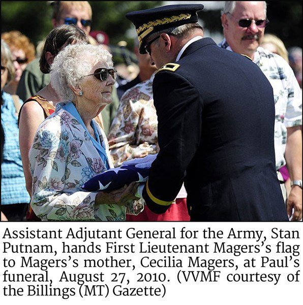 Stan Putnam, presents First Lieutenant Magers’ flag to Magers’ mother, Cecilia Magers, at Paul’s funeral