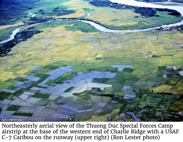 Northeasterly aerial view of the Thuong Duc Special Forces Camp airstrip at the base of the western end of Charlie Ridge with a USAF C-7 Caribou on the runway (upper right) (Ron Lester photo)
