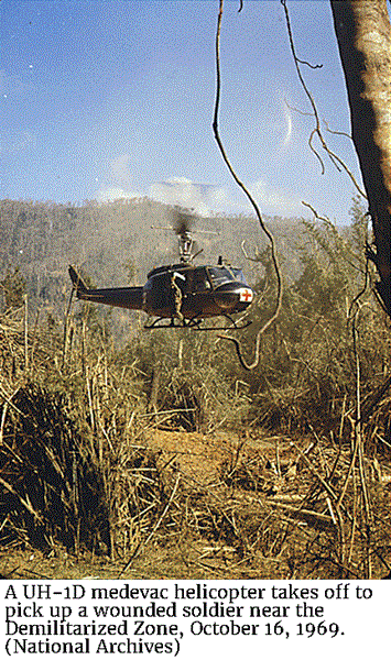 A UH-1D medevac helicopter takes off to pick up a wounded soldier near the Demilitarized Zone, October 16, 1969. (National Archives)