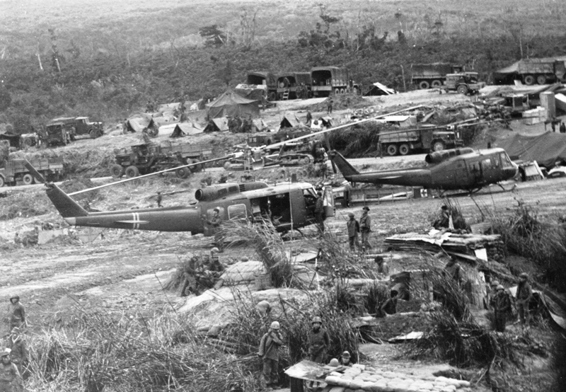 United States UH-1 helicopters, trucks, and personnel at Khe Sanh providing logistical support to Army of the Republic of Vietnam forces