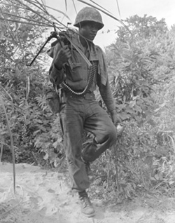 Marine Machine Gunner Carrying his Weapon