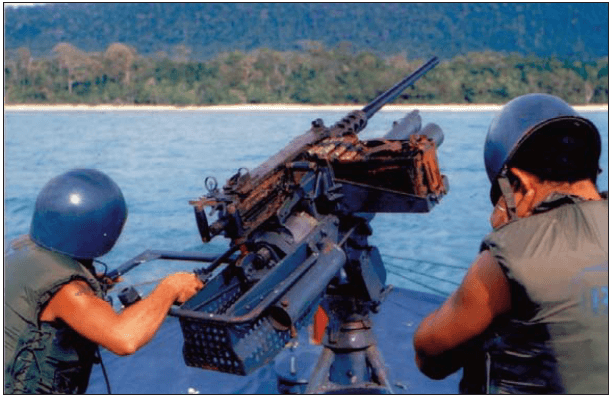 Point Banks crewmen man the Point Banks’ bow-mounted over-under .50-caliber machine gun/81mm trigger fired mortar 