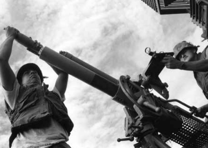 Sailors prepare to fire a patrol boat-mounted mortar.