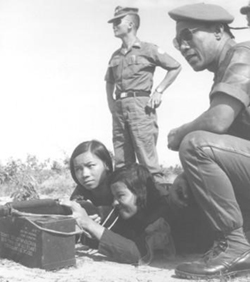 South Vietnamese Officer Teaches Two Young Women