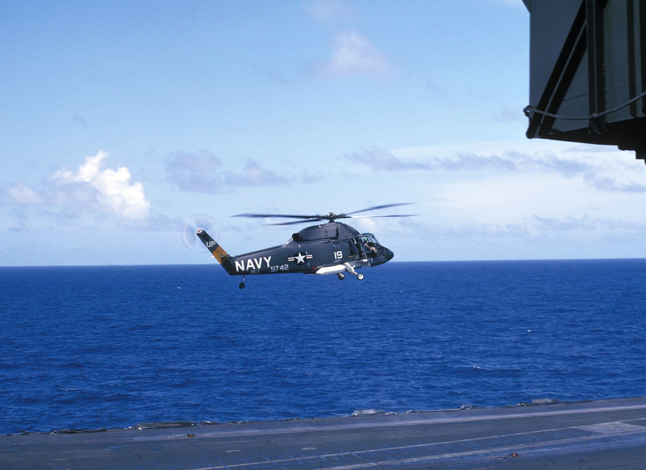 UH-2 Seasprite hovers over the flight deck of the aircraft carrier USS Kitty Hawk in the South China Sea in March 1966, just weeks before Lieutenant JG Zerbe and Seaman Underhill were killed during a similar maneuver. 