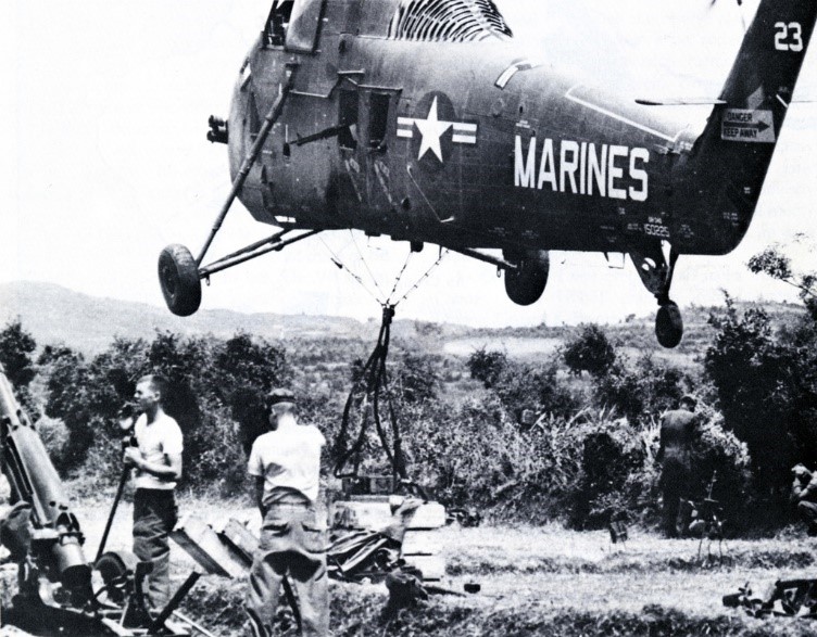 U.S. Marine Corps UH-34 helicoptors taking off with external cargo load, circa August 1965, during Operation STARLITE 
